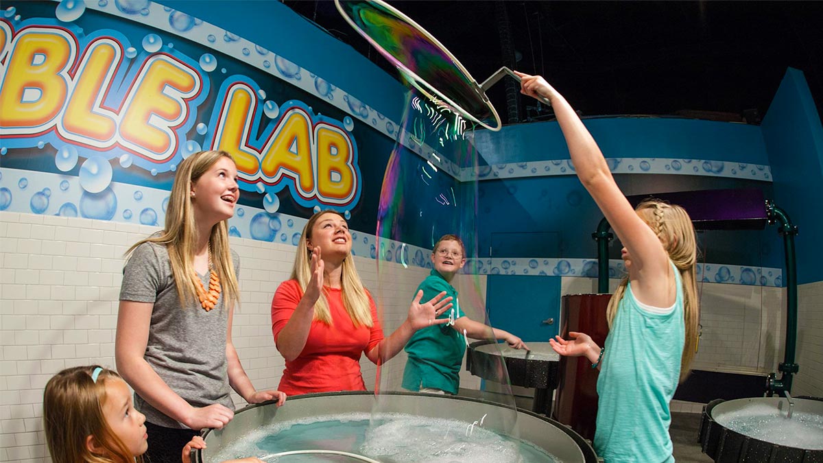 Child playing at the Bubble Lab at WonderWorks - Pigeon Forge, Tennessee, USA